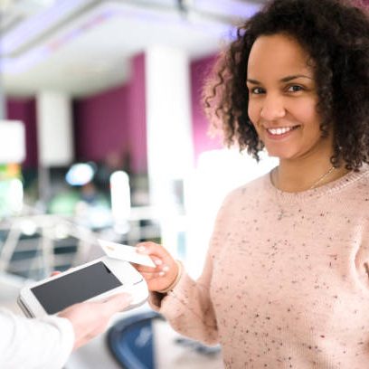 Young black woman pays her bills at a gaming club. Young black woman pays her bills at a gaming club.